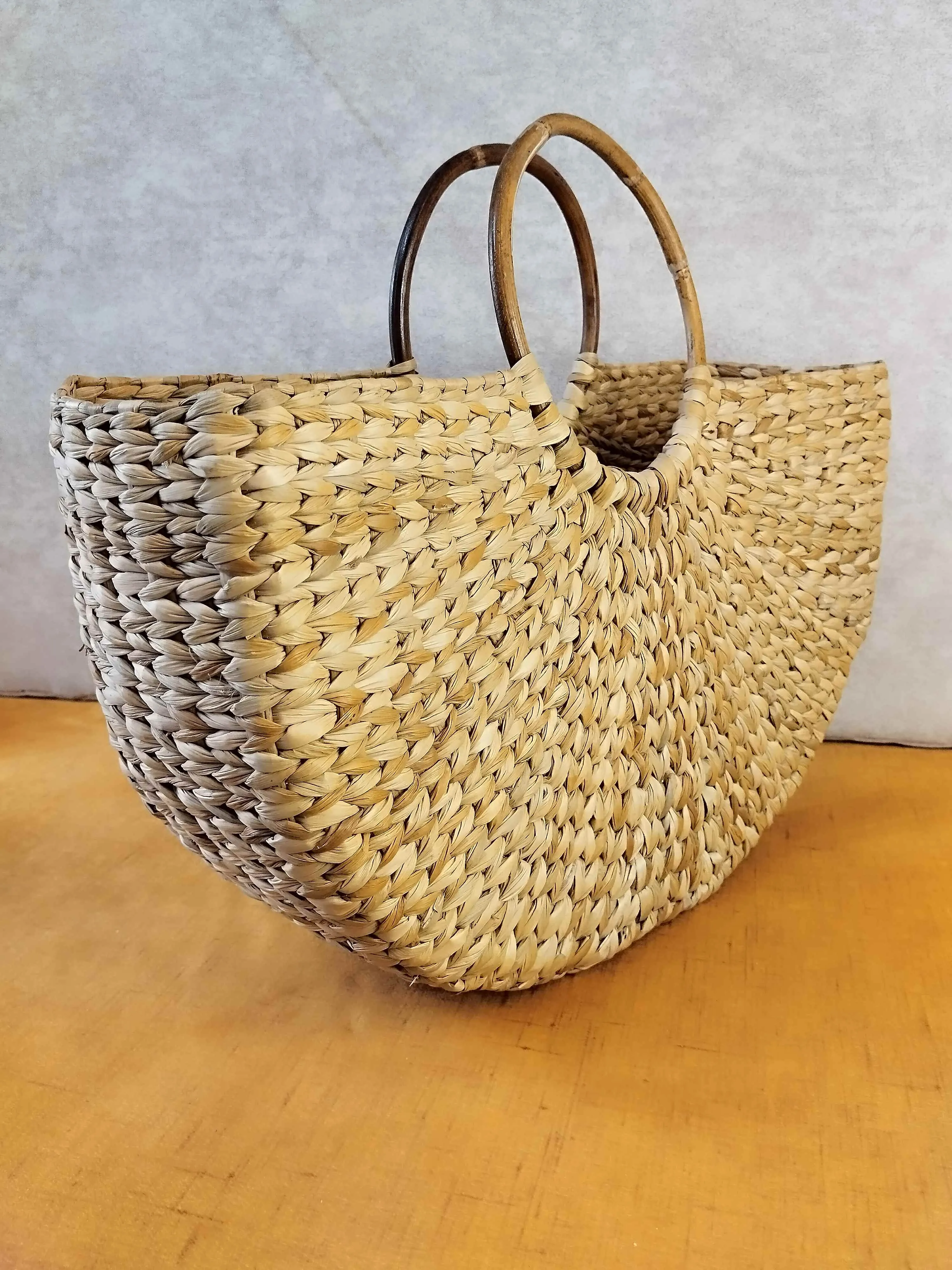 Handwoven Grass Bag with Vibrant Scarf Accent