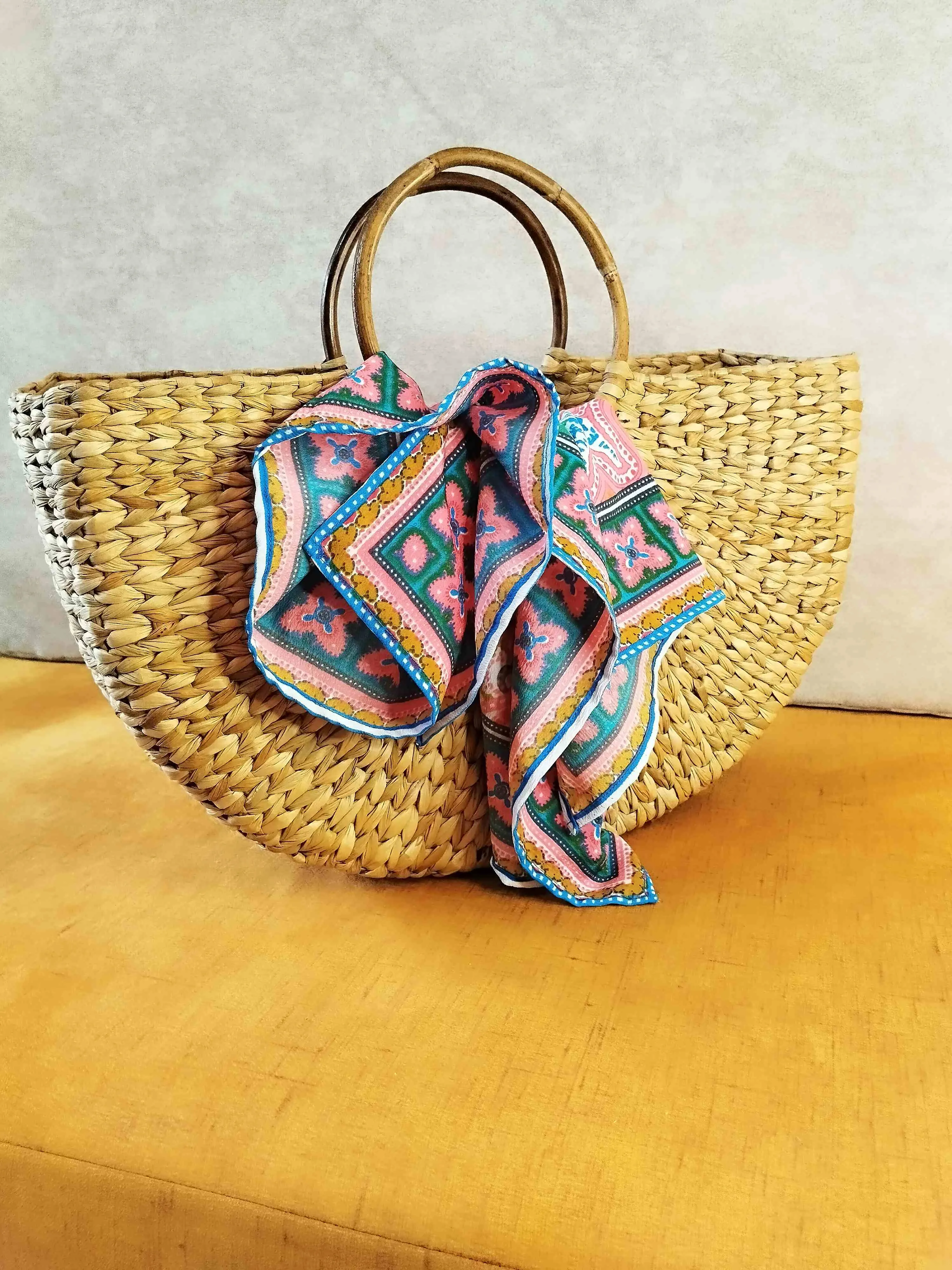 Handwoven Grass Bag with Vibrant Scarf Accent